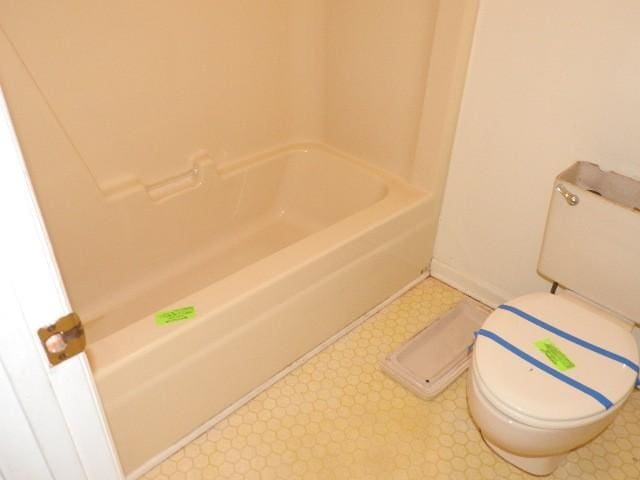 203 Valleydale St, Smyrna, TN 37167 - bathroom featuring tile patterned floors, toilet, a tub to relax in, and baseboards