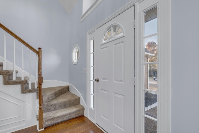 entrance foyer with dark wood finished floors and stairway