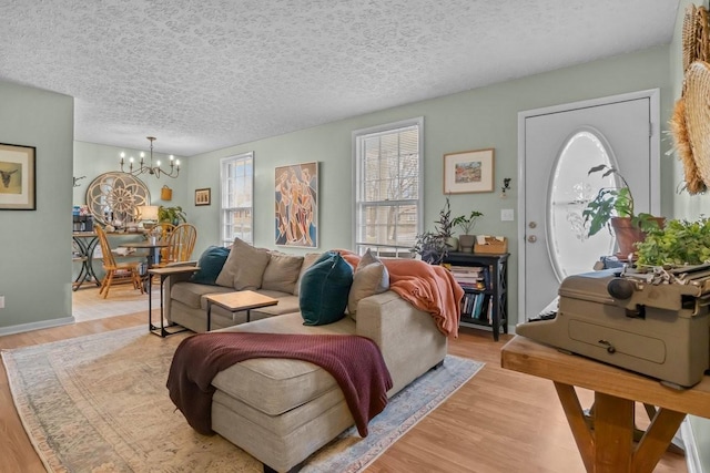 109 Robin Hood Rd, Dickson, TN 37055 - living area featuring a textured ceiling, light wood-style floors, and a chandelier