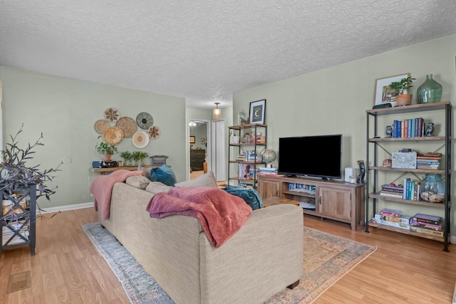 109 Robin Hood Rd, Dickson, TN 37055 - living room with baseboards, wood finished floors, and a textured ceiling