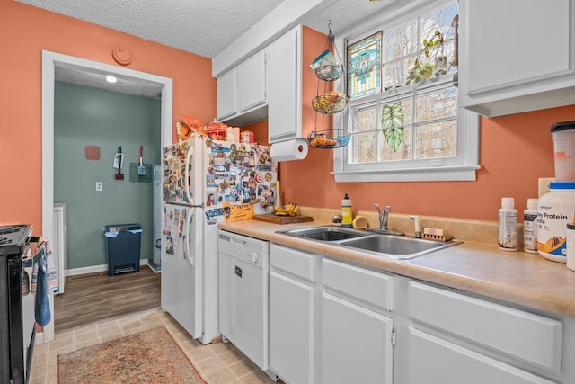 109 Robin Hood Rd, Dickson, TN 37055 - kitchen featuring a sink, a textured ceiling, white dishwasher, white cabinets, and stainless steel range with gas cooktop