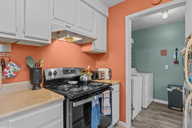109 Robin Hood Rd, Dickson, TN 37055 - kitchen featuring independent washer and dryer, a textured ceiling, under cabinet range hood, and black / electric stove