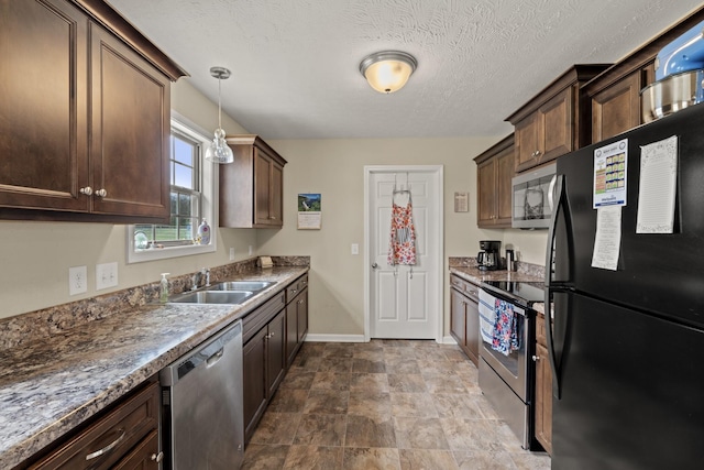 kitchen featuring a sink, baseboards, appliances with stainless steel finishes, and dark brown cabinets
