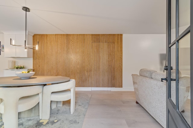 dining room featuring wood walls
