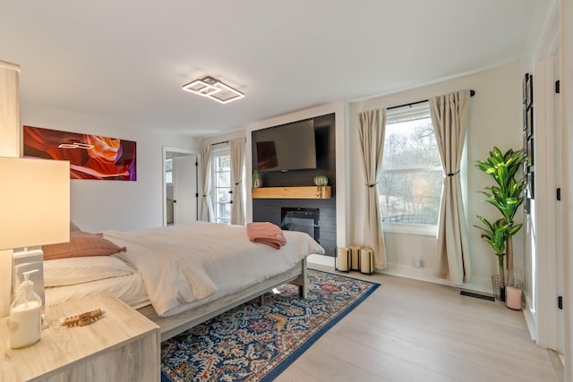 bedroom featuring visible vents and wood finished floors