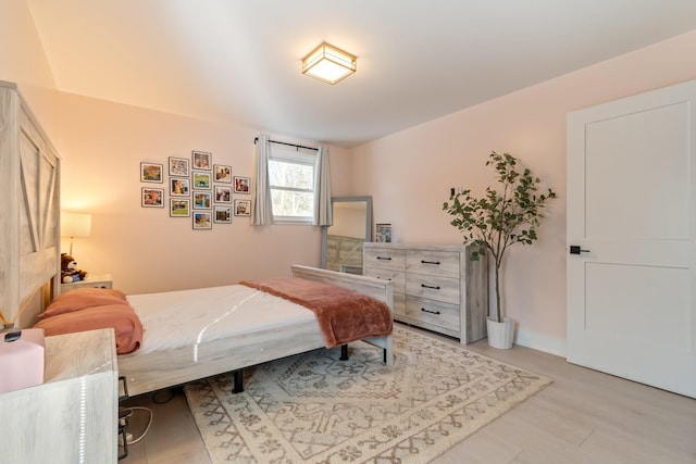 bedroom with baseboards and light wood finished floors