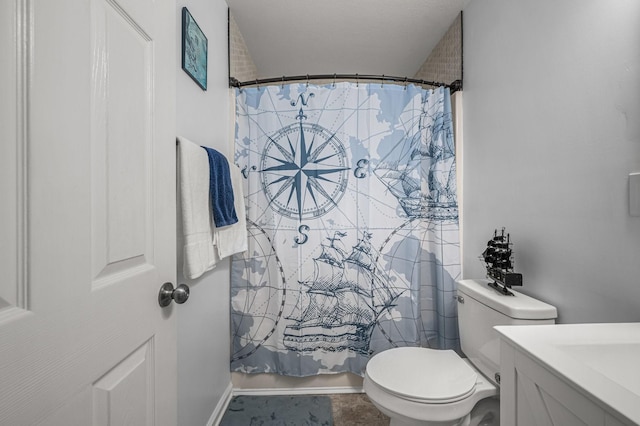 bathroom featuring toilet and vanity