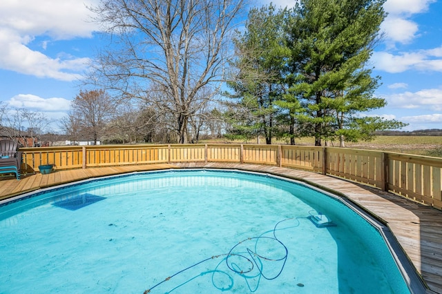 view of swimming pool with a deck and a fenced in pool