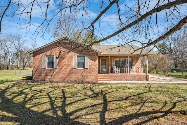view of front of house featuring brick siding, crawl space, covered porch, and a front yard
