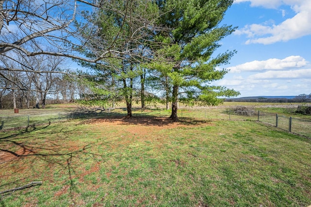 view of yard featuring a rural view and fence