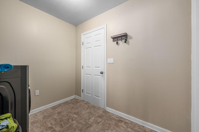 laundry area with laundry area, washer / clothes dryer, and baseboards