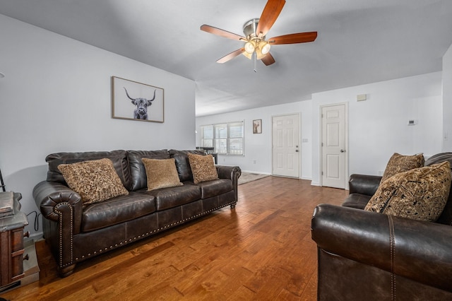 living room with baseboards, a ceiling fan, and wood finished floors