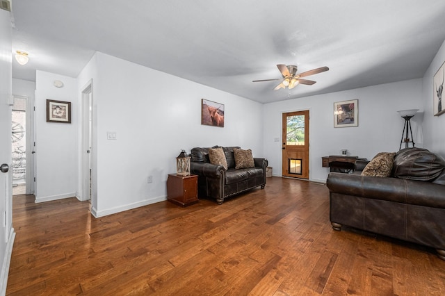 living area featuring baseboards, ceiling fan, and hardwood / wood-style flooring