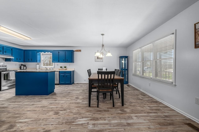 dining space with visible vents, baseboards, a healthy amount of sunlight, and wood finished floors