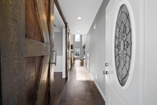 1044 Thrasher Dr, Clarksville, TN 37040 - hall featuring a barn door, baseboards, and dark wood-style flooring