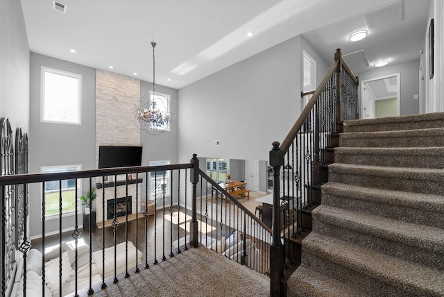 1044 Thrasher Dr, Clarksville, TN 37040 - stairway featuring visible vents, a fireplace, baseboards, and wood finished floors