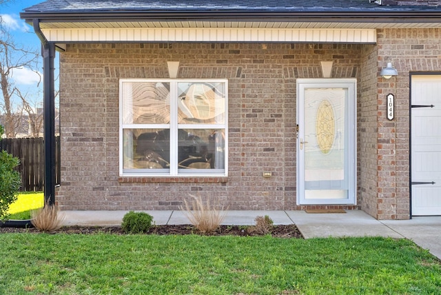 1044 Thrasher Dr, Clarksville, TN 37040 - property entrance featuring a garage, fence, brick siding, and roof with shingles