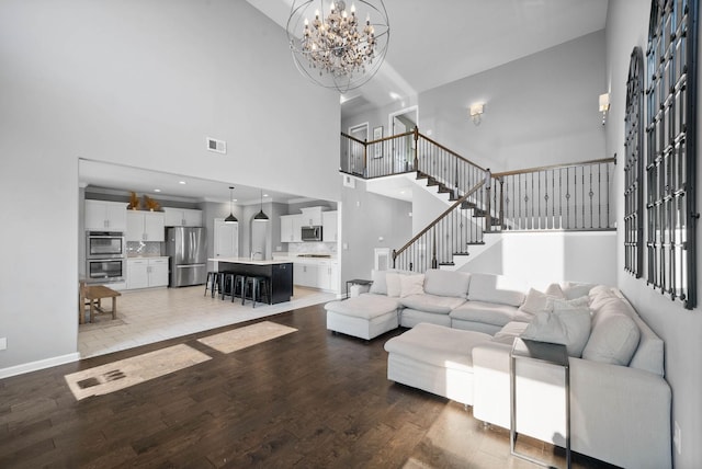 1044 Thrasher Dr, Clarksville, TN 37040 - living room with visible vents, an inviting chandelier, recessed lighting, stairs, and hardwood / wood-style flooring