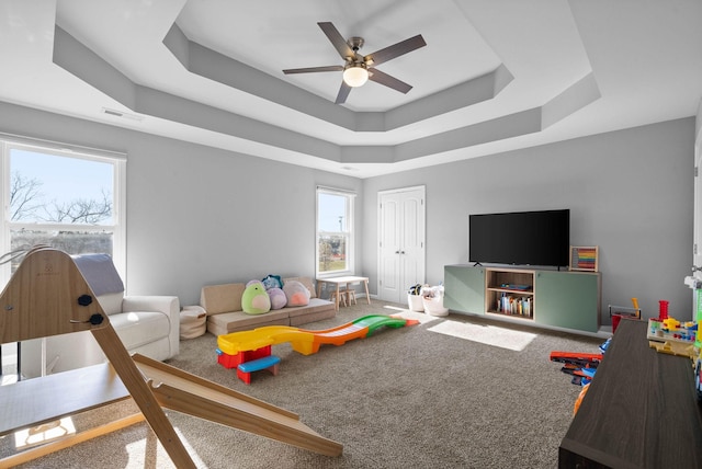 1044 Thrasher Dr, Clarksville, TN 37040 - rec room featuring visible vents, baseboards, carpet, a tray ceiling, and a ceiling fan