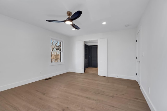 unfurnished bedroom featuring recessed lighting, visible vents, light wood-style flooring, and baseboards