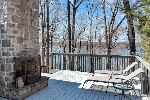 wooden terrace featuring a water view