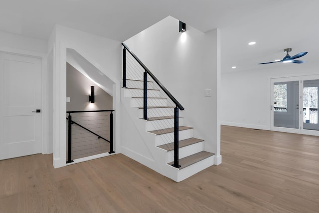 staircase with recessed lighting, wood finished floors, baseboards, and ceiling fan