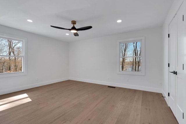 unfurnished bedroom featuring recessed lighting, visible vents, multiple windows, and light wood-style floors