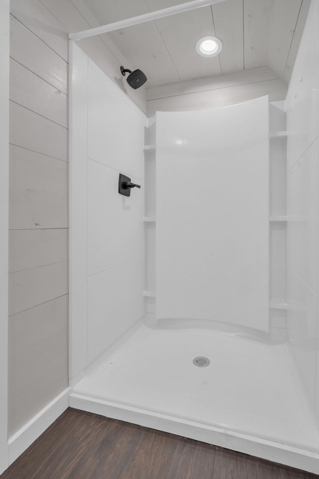 full bath featuring a stall shower and wood finished floors