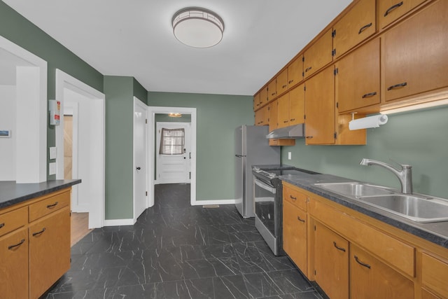 kitchen with baseboards, a sink, under cabinet range hood, appliances with stainless steel finishes, and marble finish floor