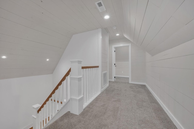 corridor featuring recessed lighting, visible vents, an upstairs landing, and carpet flooring
