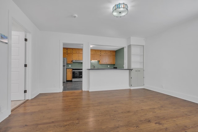 unfurnished living room featuring dark wood-style floors and baseboards