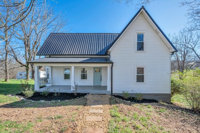 view of front facade with covered porch and metal roof