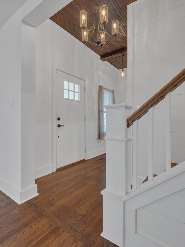 foyer entrance featuring wooden ceiling, baseboards, an inviting chandelier, and wood finished floors