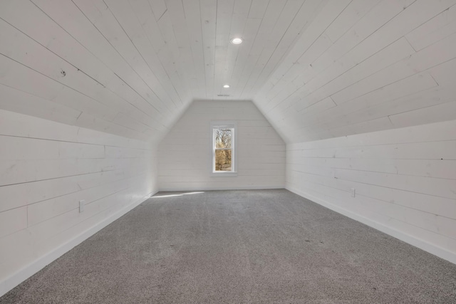 additional living space with wooden walls, lofted ceiling, recessed lighting, wooden ceiling, and carpet flooring
