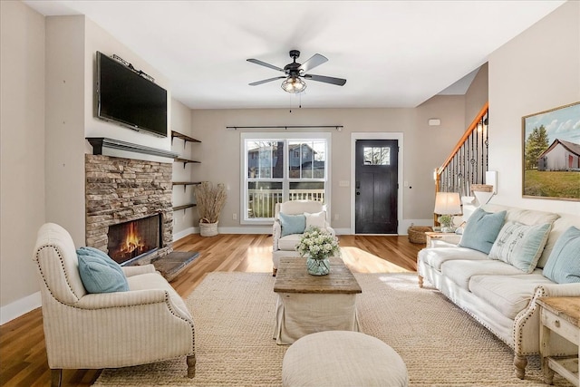 2023 Hillcrest Dr, Greenbrier, TN 37073 - living area featuring wood finished floors, a fireplace, ceiling fan, and baseboards