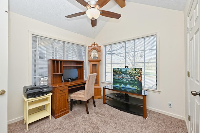 home office with a textured ceiling, lofted ceiling, light colored carpet, and ceiling fan