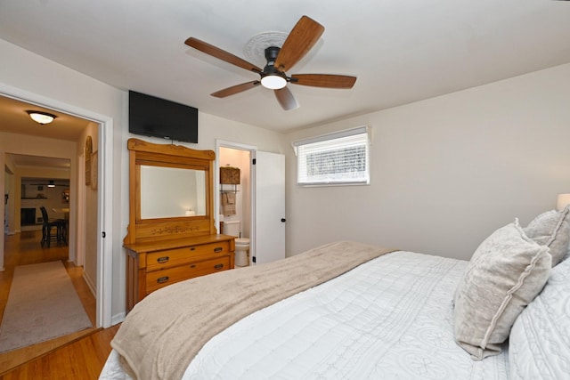 bedroom with connected bathroom, light wood-style floors, and a ceiling fan