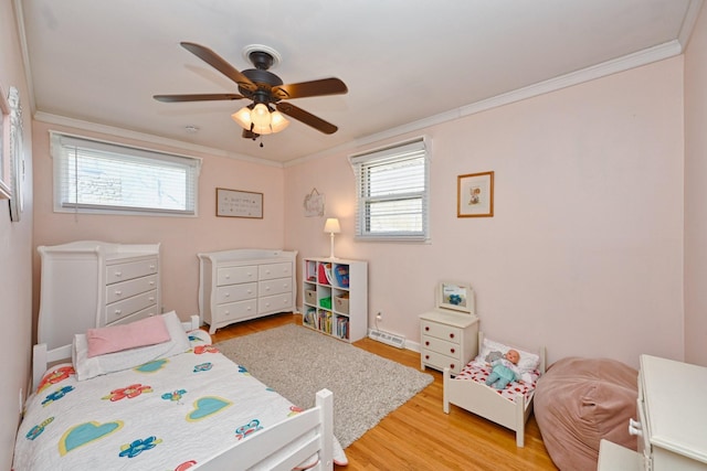 bedroom with baseboards, ceiling fan, crown molding, and light wood finished floors