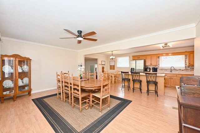 dining area with ornamental molding, baseboards, light wood finished floors, and ceiling fan