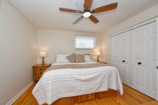 bedroom featuring a closet, baseboards, a ceiling fan, and light wood finished floors