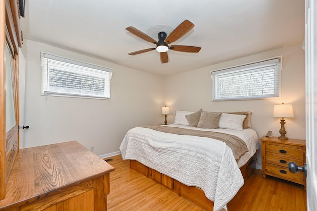 bedroom featuring visible vents, ceiling fan, baseboards, and light wood-style floors