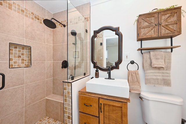 full bath with vanity, toilet, and a shower stall