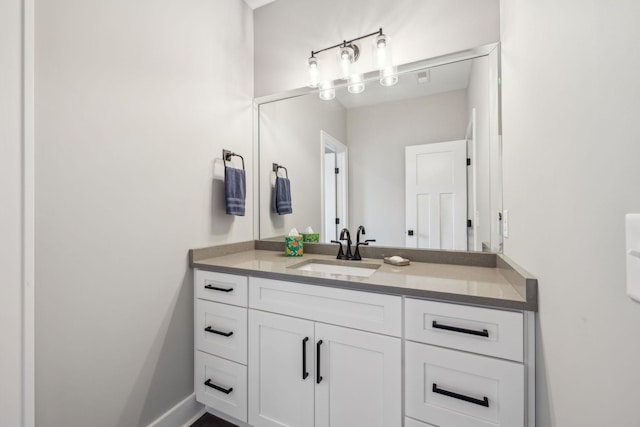 bathroom with vanity and baseboards