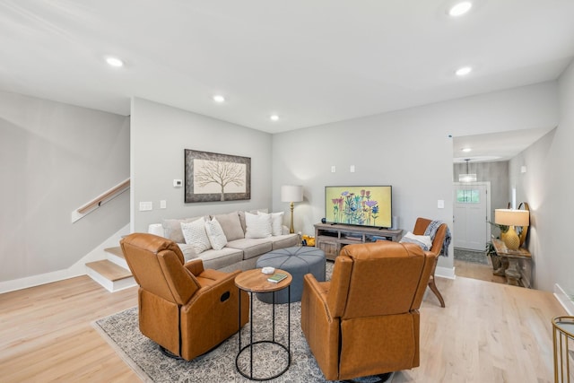 living room with recessed lighting, baseboards, stairs, and wood finished floors