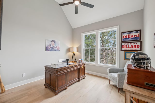 office space featuring baseboards, high vaulted ceiling, light wood-style floors, and a ceiling fan