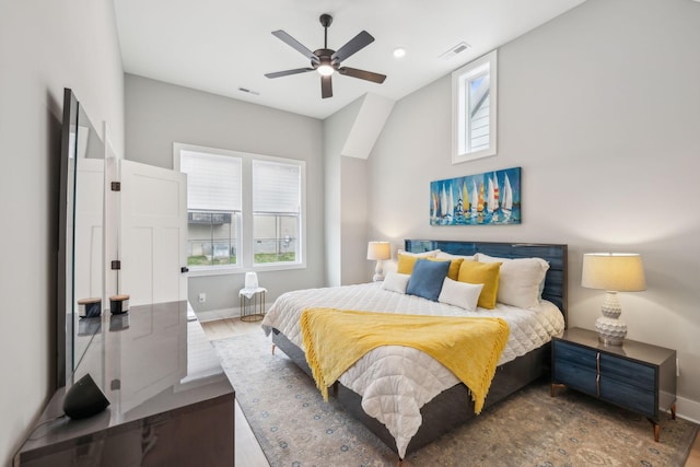 bedroom featuring wood finished floors, baseboards, and visible vents