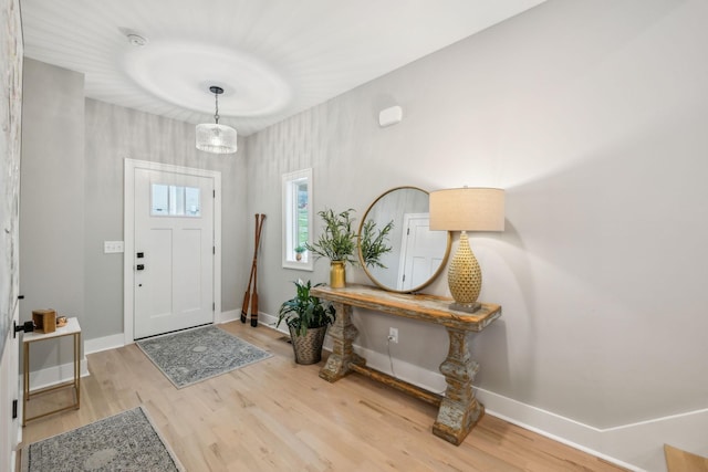 entrance foyer with baseboards and wood finished floors