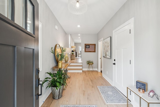 foyer featuring baseboards, recessed lighting, and light wood finished floors