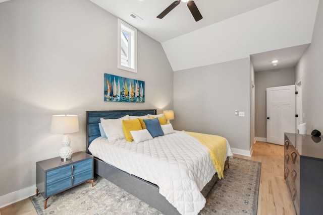 bedroom featuring baseboards, lofted ceiling, light wood-style flooring, and ceiling fan