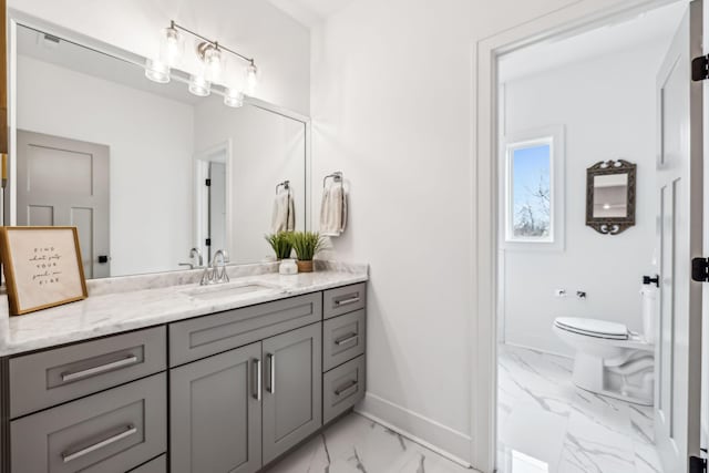 bathroom with baseboards, marble finish floor, toilet, and vanity